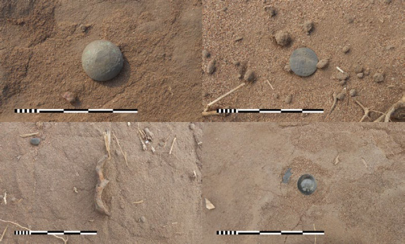 Figura 8. Selección de artefactos hallados en el sitio a lo largo del camino: a) botón metálico tipo domo, con escudo nacional; b) botón plano, con escudo nacional; c) posible gatillo de hierro; y d) decantador de botella de vidrio soterrado en el sustrato duro